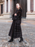 Refined mahogany mink fur coat styled with black boots for a polished winter look. A luxurious addition to any wardrobe.