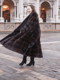 Full-length mahogany mink fur coat with a flowing silhouette and plush texture. A statement piece for refined winter fashion.