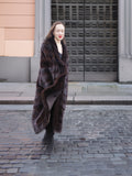 Full-length mahogany mink fur coat with a rich brown hue, styled for a refined winter look. A luxurious and warm outerwear piece.