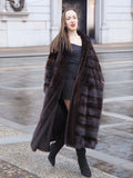 Chic mahogany mink fur coat styled with a black outfit, perfect for elegant winter fashion. A luxurious and warm outerwear choice.