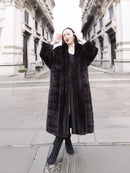 Full-length mahogany mink fur coat with a dramatic silhouette, exuding sophistication and warmth. A timeless winter essential.