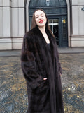 Chic mahogany mink fur coat styled with a black outfit, perfect for elegant winter fashion. A luxurious and warm outerwear choice.