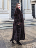 Elegant mahogany mink fur coat styled with black boots, offering a refined and warm winter look. A luxurious outerwear choice.