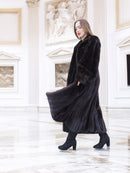 Black mink coat sways elegantly in a white marble hall, showcasing premium craftsmanship and winter luxury fashion.