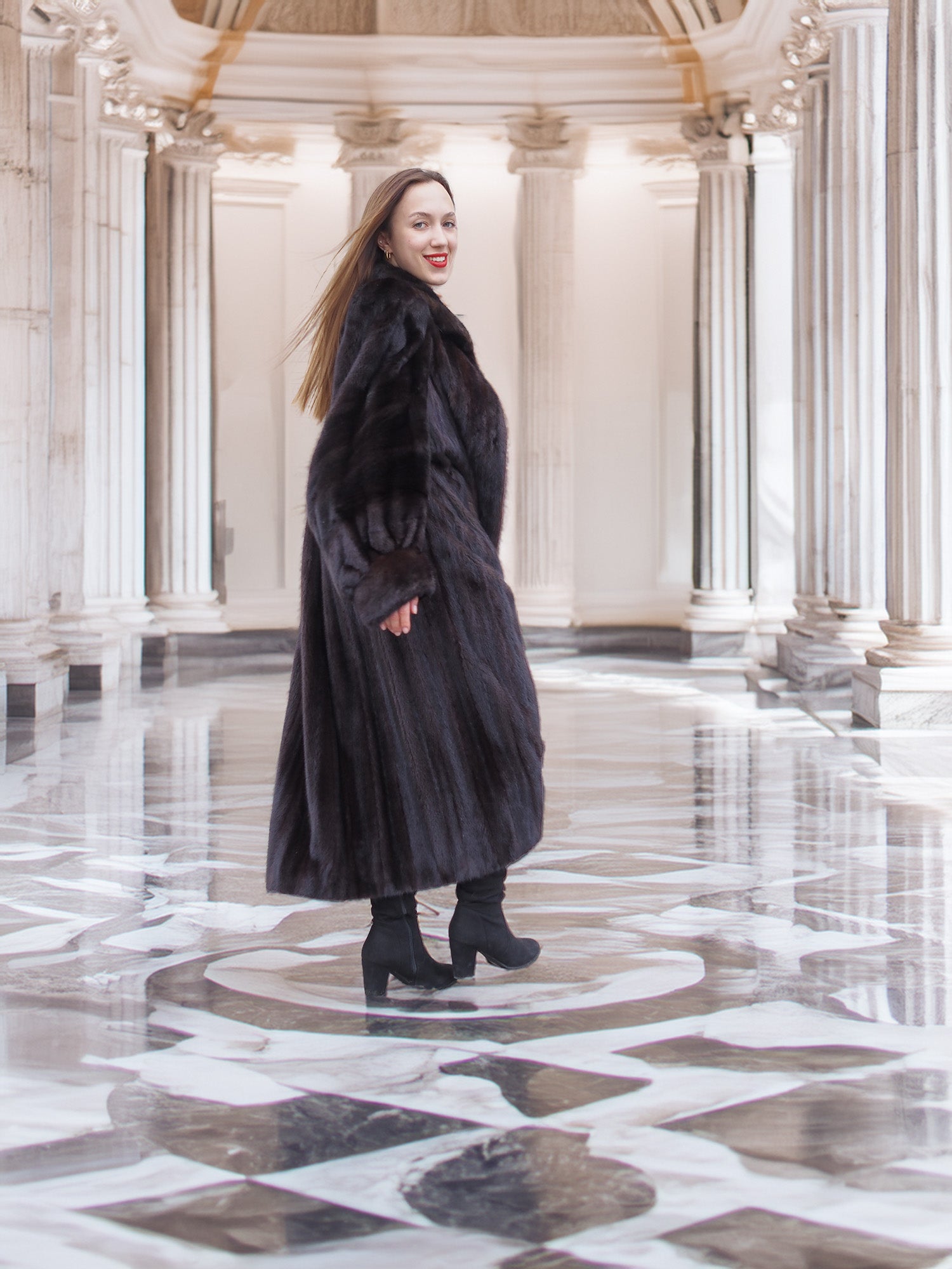Model twirls in black mink coat, revealing inner lining and dramatic sweep, perfect for luxury winter fashion collections.