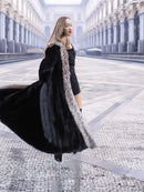 Dynamic spin in black mink coat with silver fox trim, highlighting the coat's volume and elegant lining.