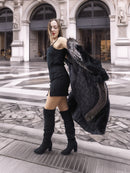 NAFA female black mink coat with indigo fox sleeves and collar in L/XL, styled over a black mini dress and knee-high boots for a chic urban look.