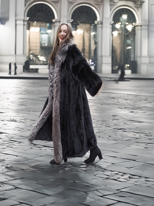 NAFA female black mink coat with indigo fox collar and sleeves in L/XL, styled outdoors with elegant black boots for winter fashion.