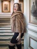 Woman wearing a fur stole in an elegant interior setting
