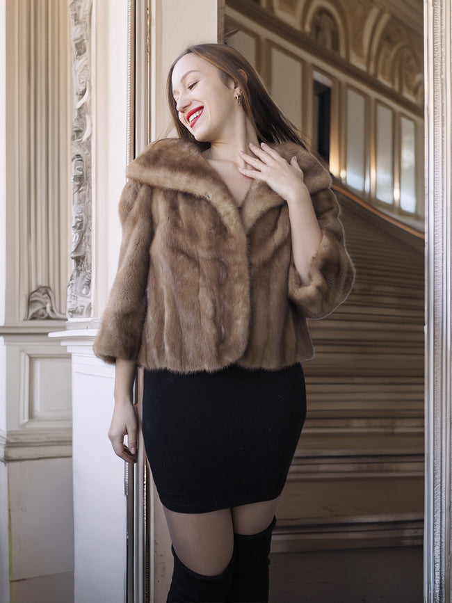 Woman wearing a fur coat in an elegant interior setting