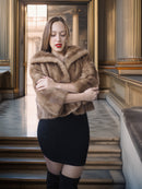 Woman wearing a fur shawl in an elegant interior setting