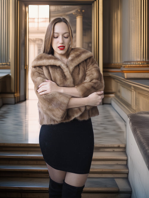 Woman wearing a fur shawl in an elegant interior setting