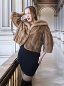 Woman wearing a fur coat in an elegant interior setting
