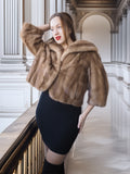 Woman wearing a fur coat in an elegant interior setting