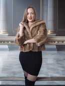Woman wearing a fur coat in an elegant interior setting