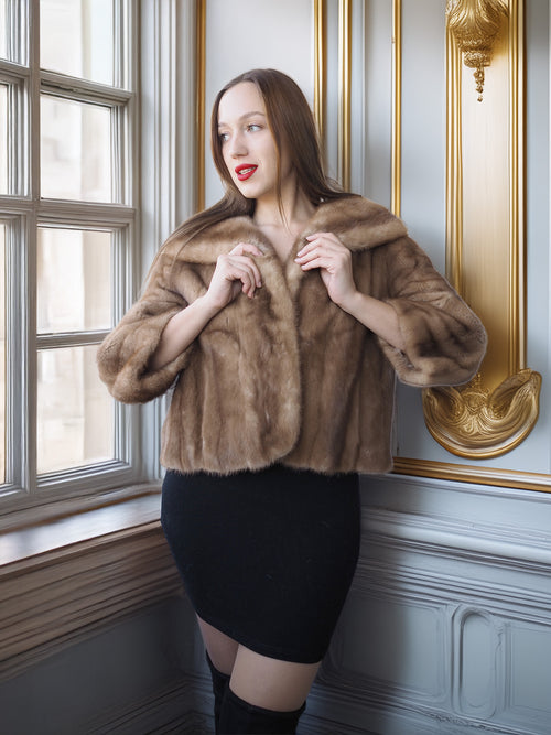 Woman wearing a fur coat in an elegant interior setting