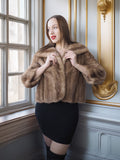 Woman wearing a fur coat in an elegant interior setting