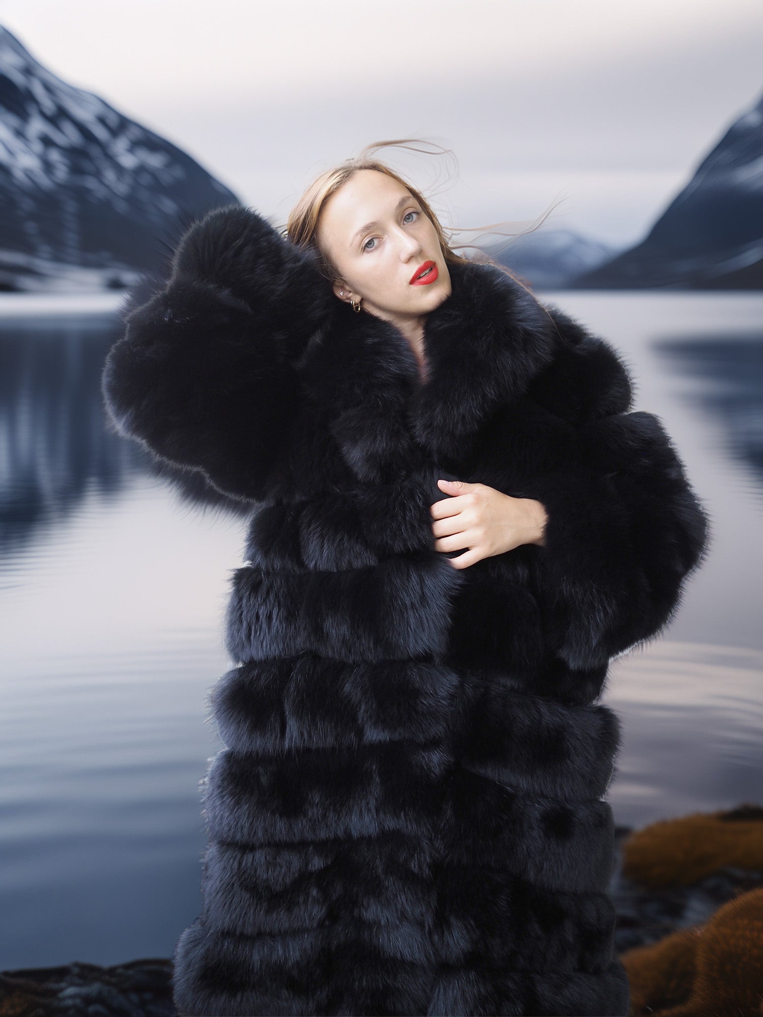 Woman wearing a fur coat with a mountainous landscape in the background