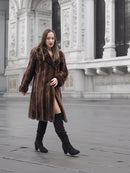 Woman walking in a dark mahogany mink fur coat, perfect for medium sizes in high-end vintage outerwear collections.