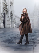 Model posing in vintage mink fur coat in a foggy cityscape, highlighting the coat's rich color and classic design.