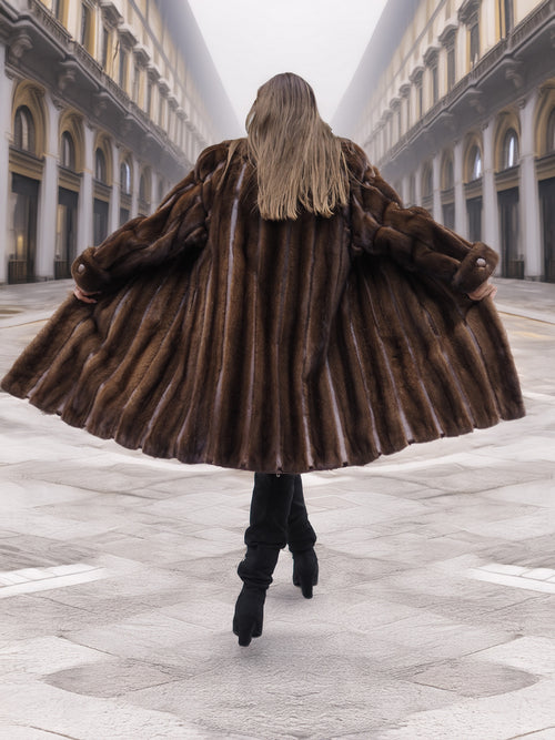 Back view of flared vintage mink fur coat in mahogany brown, showcasing premium fur texture and full silhouette.