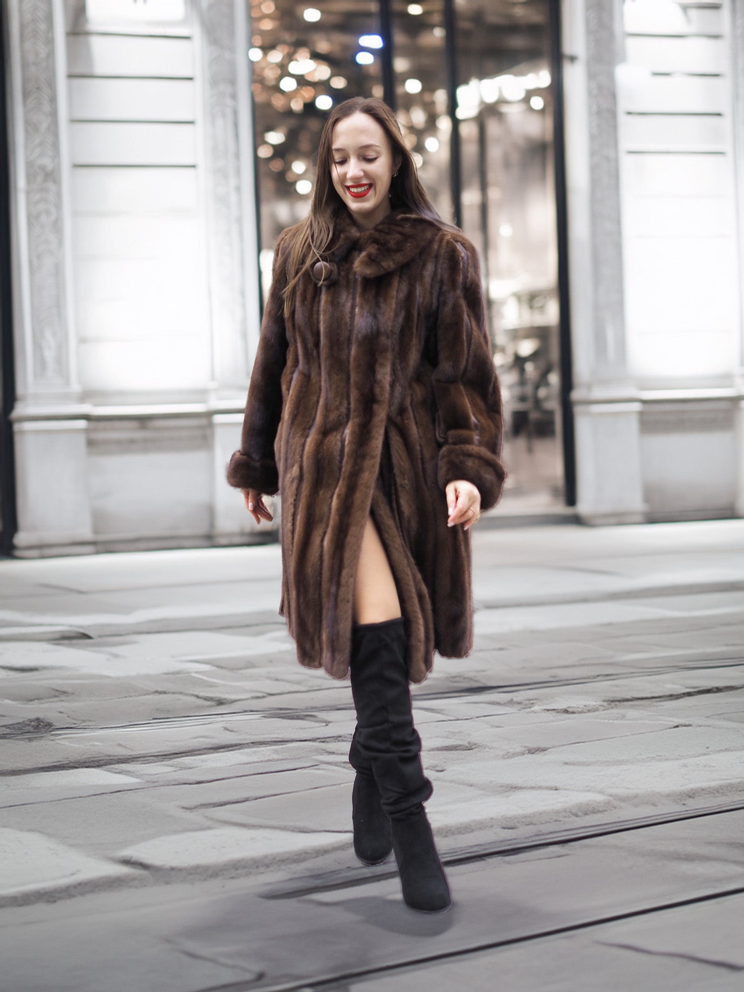 Woman walking in a luxurious dark mahogany mink fur coat, showcasing premium vintage outerwear for cold weather fashion.