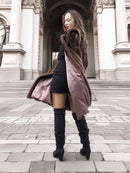 Model twirling in open vintage mink fur coat, revealing silky brown lining and elegant craftsmanship in outerwear design.