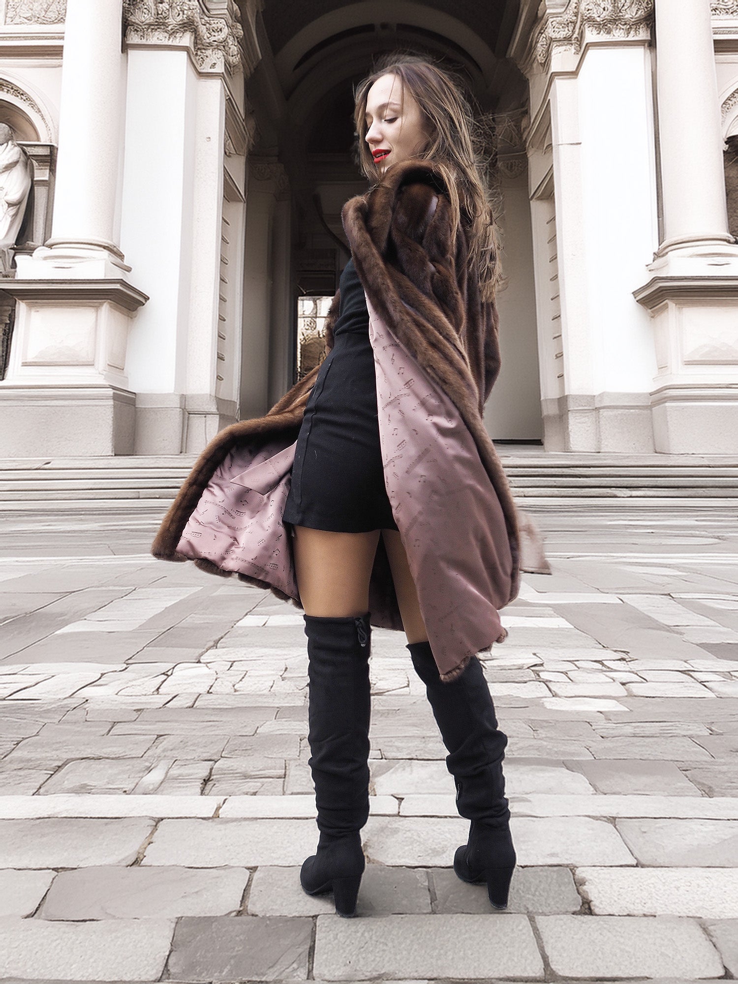 Model twirling in open vintage mink fur coat, revealing silky brown lining and elegant craftsmanship in outerwear design.