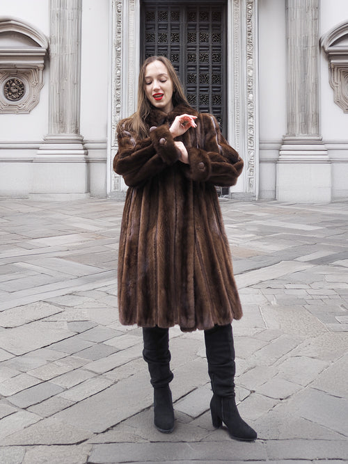 Front view of woman in dark mahogany mink fur coat, styled for medium size in elegant vintage outerwear fashion.