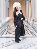 Black mink fur coat worn open over a black dress, revealing inner lining. Luxurious winter outerwear for stylish layering, size M.