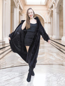 Model walking in black mink fur coat worn open over a black dress, blending elegance and warmth. Luxury winter coat, size M.