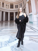 Model in black mink fur coat with one shoulder exposed, styled in a grand rotunda. Full-length fur outerwear, size M.