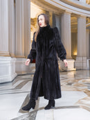 Model in black mink fur coat with structured shoulders and sleek silhouette, styled in a marble hall. Elegant winter fashion, size M.