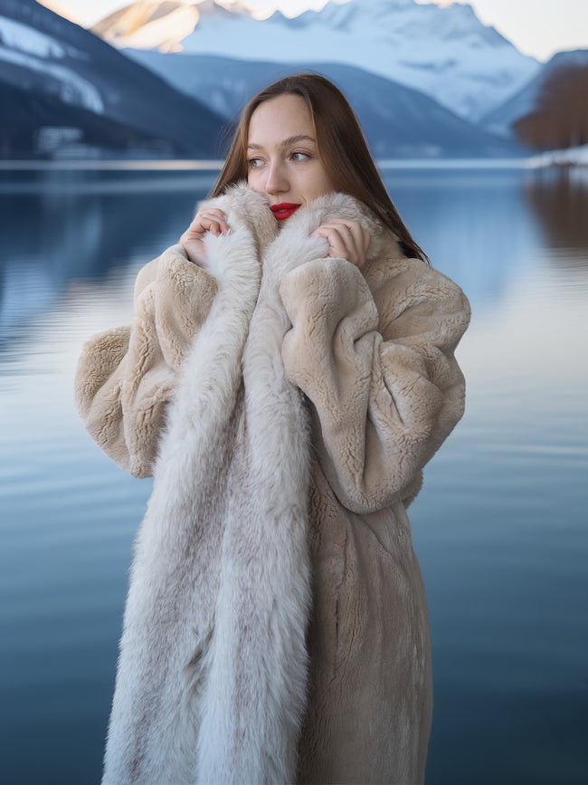 Woman wearing a fur coat with a mountainous landscape in the background