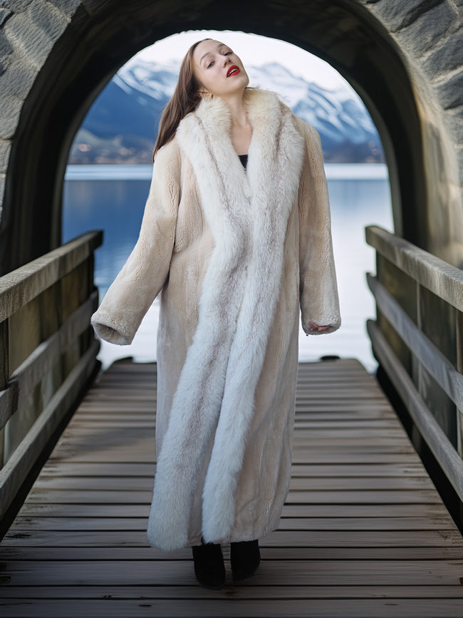 Woman in a fur coat standing on a wooden bridge with a scenic background