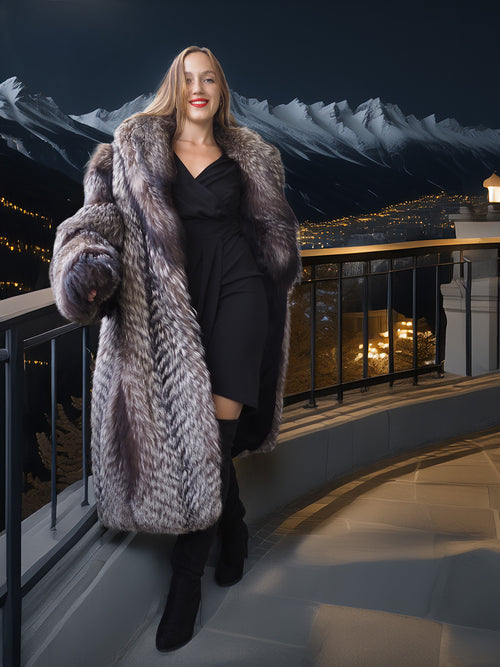 Woman in a fur coat standing on a balcony with mountain and cityscape background