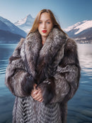 Woman wearing a fur coat with a mountainous landscape in the background