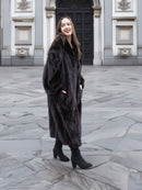 Model wearing a full-length black mink fur coat with a soft sheen, perfect for upscale winter outerwear fashion.