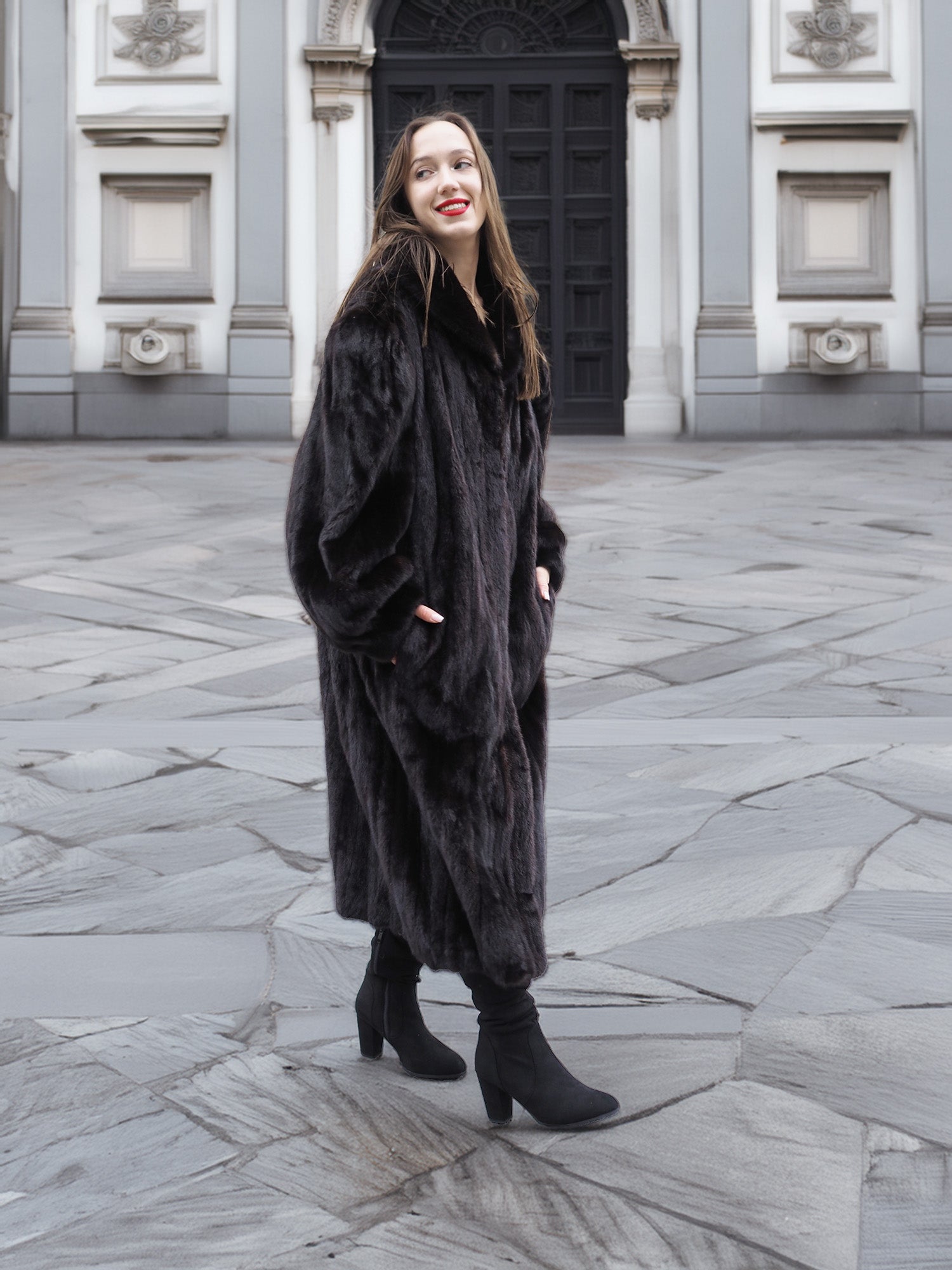 Model wearing a full-length black mink fur coat with a soft sheen, perfect for upscale winter outerwear fashion.