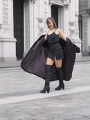 Model showcases the interior lining of the black mink fur coat, highlighting its tailored fit and stylish appeal for luxury outerwear fashion.