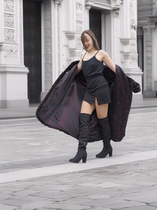 Model showcases the interior lining of the black mink fur coat, highlighting its tailored fit and stylish appeal for luxury outerwear fashion.