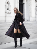 Black mink fur coat opened to show its detailed lining, styled with a black outfit for a fashionable winter look.