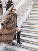 Espresso Mink Long Coat - Regal Swing styled on marble stairs, paired with black mini dress and boots for luxury outerwear appeal.