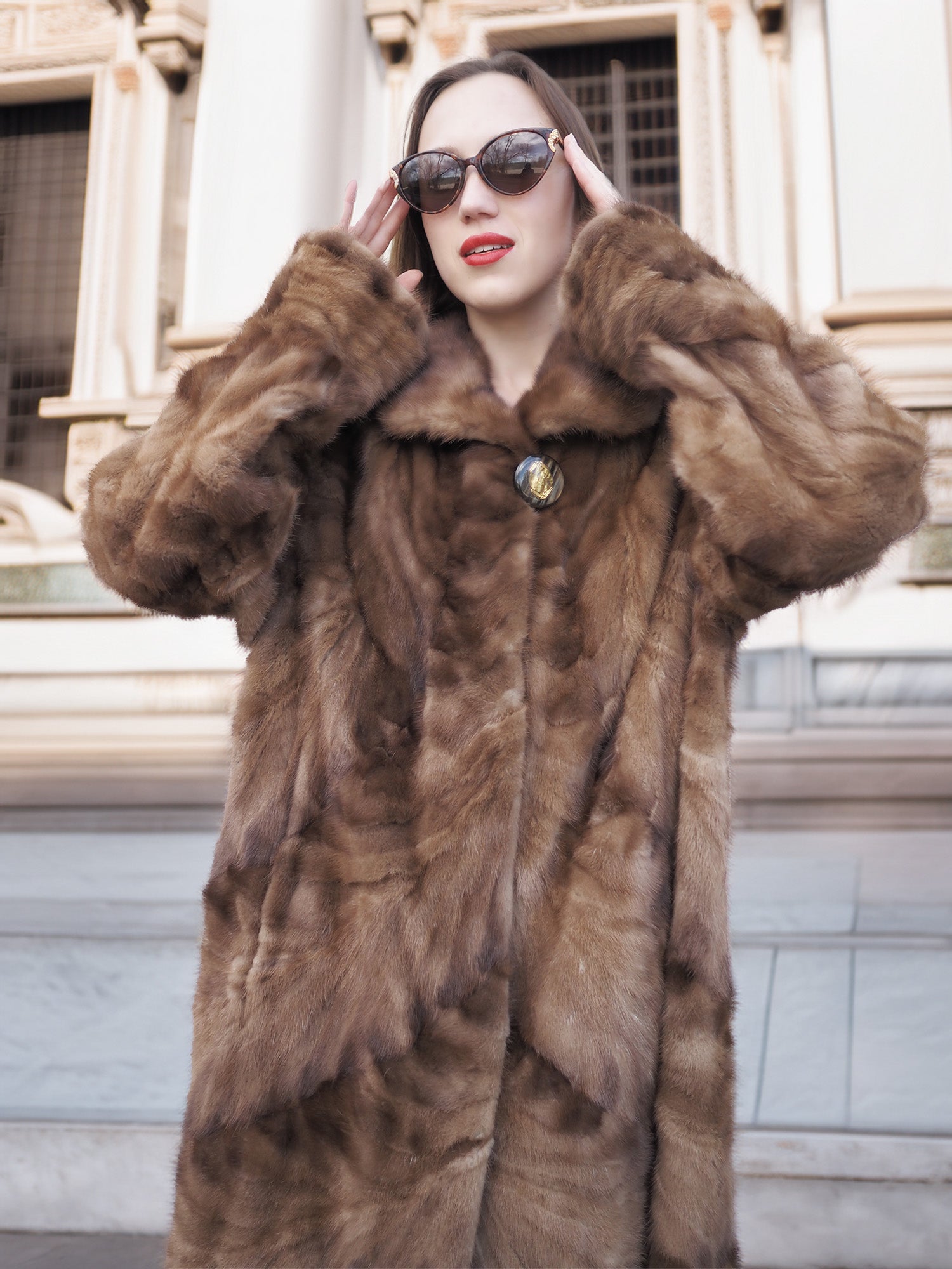 Espresso Mink Long Coat - Regal Swing close-up with sunglasses, showcasing plush collar and natural mink fur pattern.