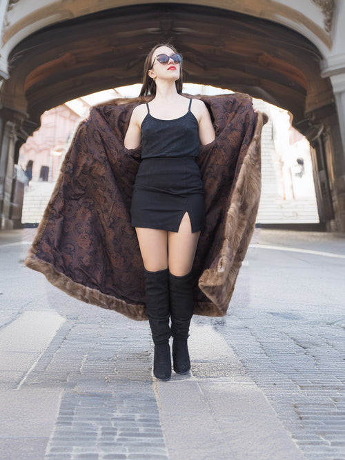 Espresso Mink Long Coat - Regal Swing opened to reveal paisley inner lining, paired with a black mini dress and high boots.