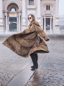 Espresso Mink Long Coat - Regal Swing flaring in motion, showcasing full 50-inch length and elegant texture in outdoor urban setting.