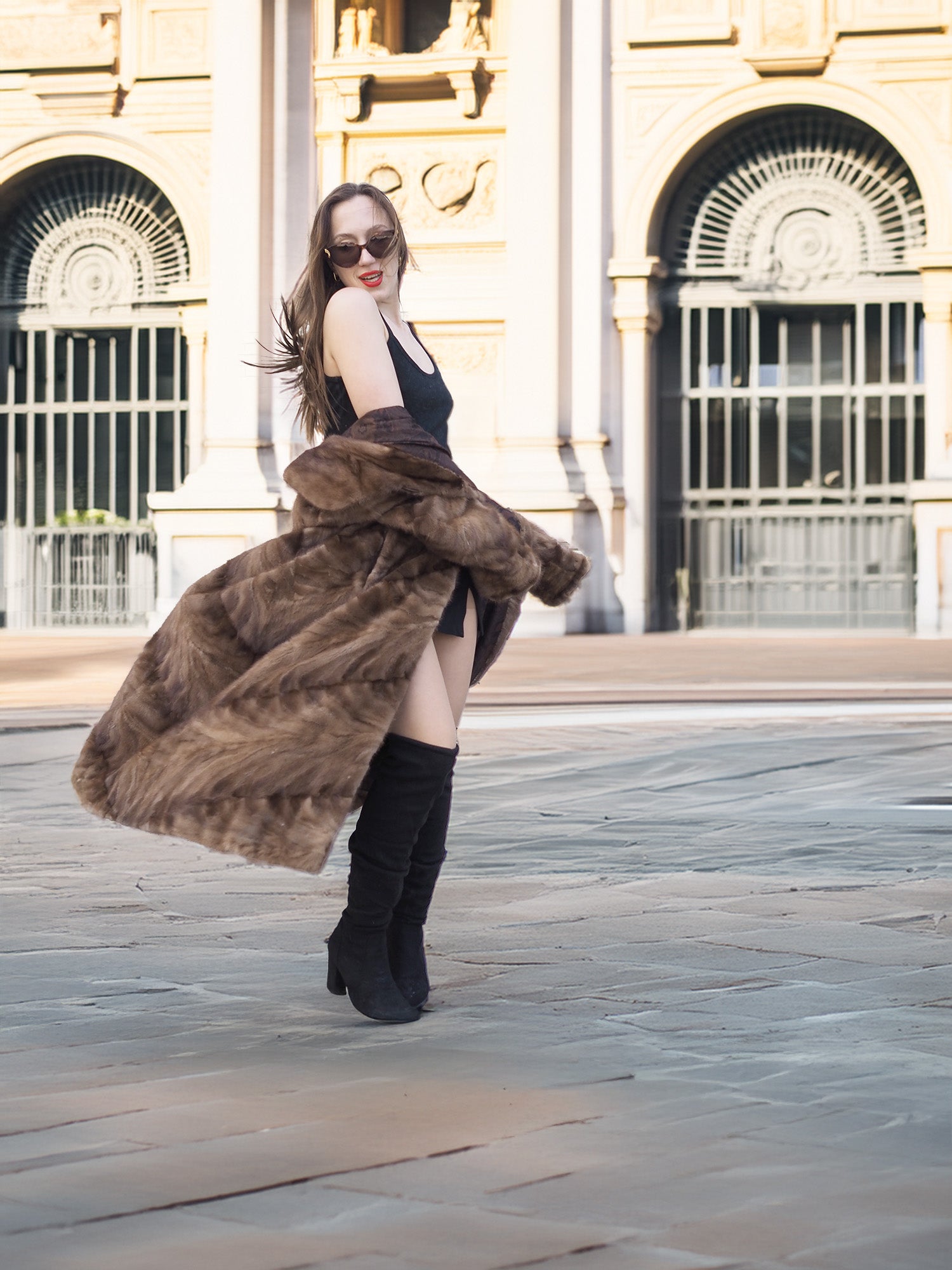 Espresso Mink Long Coat - Regal Swing flaring in motion, styled with black mini dress and boots for high-end winter fashion.