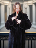 Woman wearing a black fur coat in an elegant interior setting