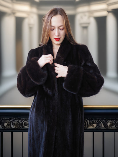 Woman wearing a black fur coat in an elegant interior setting
