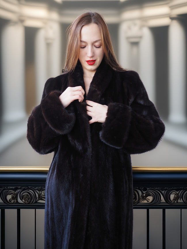 Woman wearing a black fur coat in an elegant interior setting